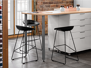Modern interior design workshop featuring finishes, filing, counter, and stools.