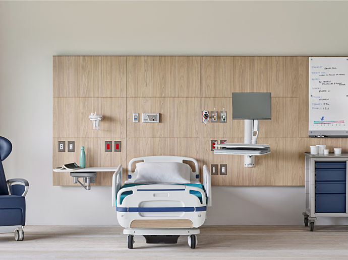 Healthcare headwall with recliner, medical cart, and medical storage.